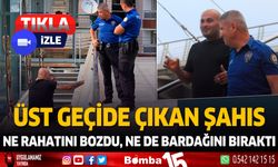 Üst geçide çıktı. Ne rahatlığını bozdu ne de bardağını bıraktı