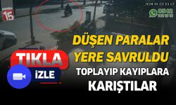 Motosikletten düşen paralar yola savruldu